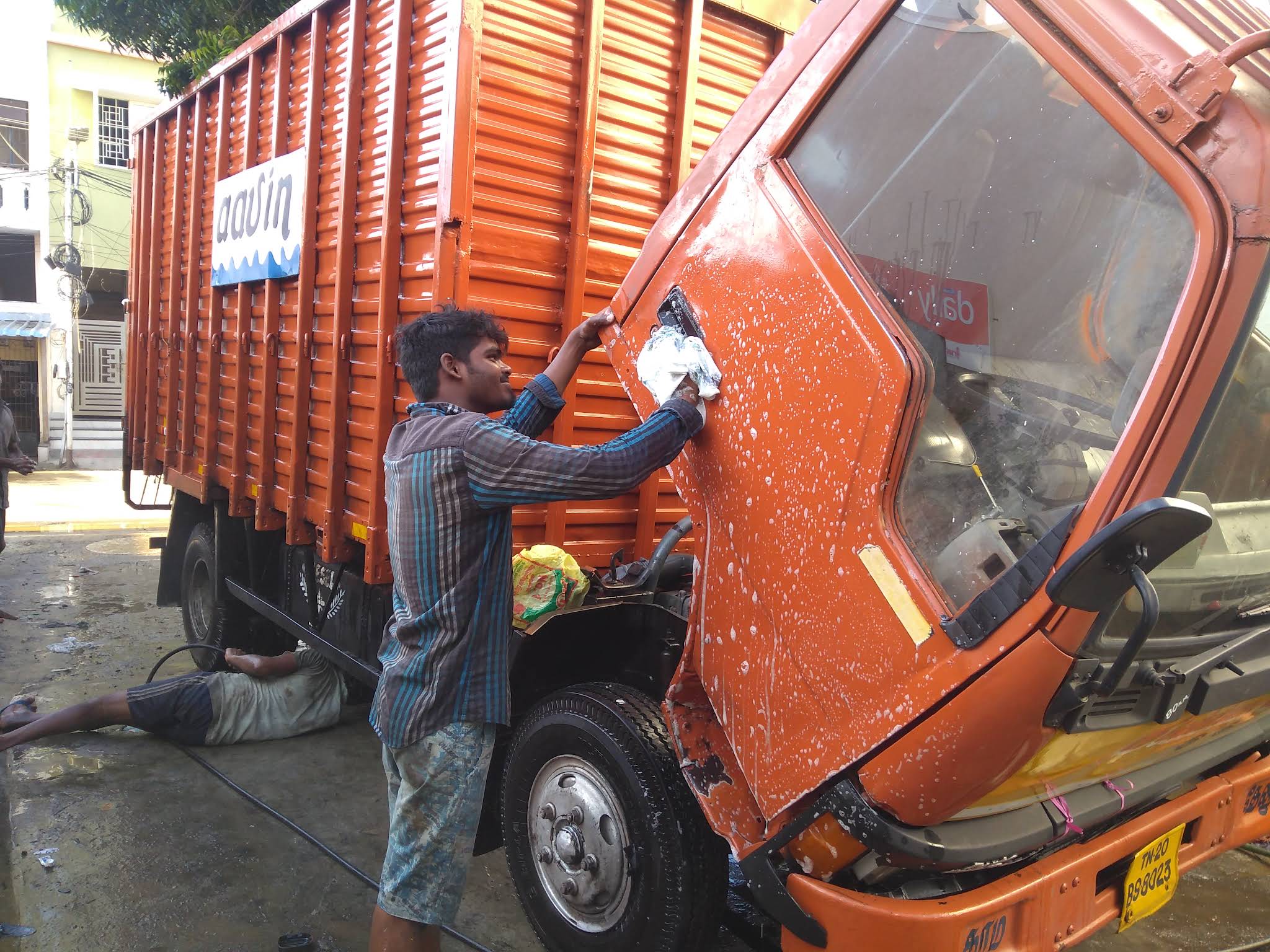 Car being washed with water spray